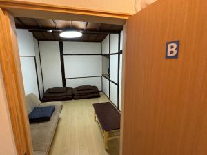 Postel nebo postele na pokoji v ubytování ゲストハウス千福