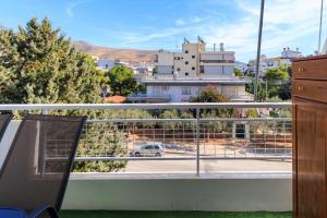 a balcony with a view of a city at AIOLOS elegant escapes GLYFADA apartment in Athens
