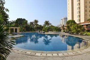 a large swimming pool in the middle of a building at Luxury 3BR Apartment at Sudirman Tower Condominium By Travelio in Jakarta