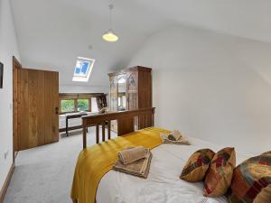 a bedroom with a bed with two hats on it at Lane End Cottage North Molton in North Molton