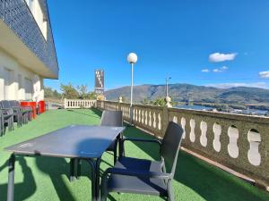 a table and chairs on the balcony of a building at Hotel Berna - Valdeorras - Camino de Invierno in La Rúa +13 photos