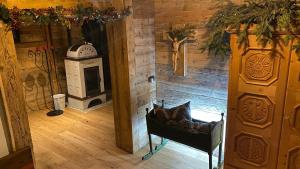 a room with a stove and a chair in a room at Hotel Almhof in San Candido +103 photos