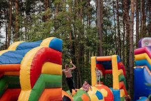 two children playing in an inflatable play structure at Leśny Apartament nad Zalewem VIP EDITION in Kielce