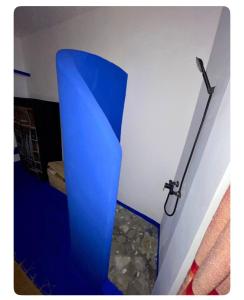 a blue object is on the corner of a room at Casa bleuté in Asilah +17 photos