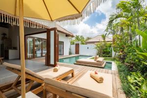 an outdoor patio of a villa with a swimming pool at Villa Lounes 1 - Luxury 1BR Villa Walking Distance to the Beach in Tanah Lot +51 photos