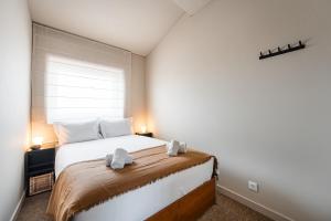 Ένα ή περισσότερα κρεβάτια σε δωμάτιο στο GuestReady - A charming duplex home near Boavista +41 φωτογραφίες