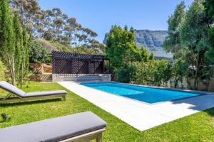 a swimming pool in the yard of a house at Bay Haven Collection in Cape Town
