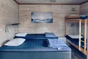 Postel nebo postele na pokoji v ubytování Piilijärvi Camping