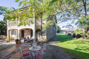 a patio with chairs and a table in front of a house at Casa Da Puza in Forcarei
