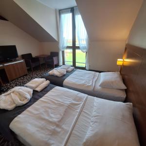 Posteľ alebo postele v izbe v ubytovaní Hotel i Aquapark Olender