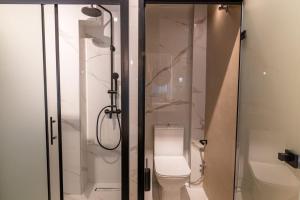 a bathroom with a shower with a toilet and a shower at MKproperties in Volos +2 photos