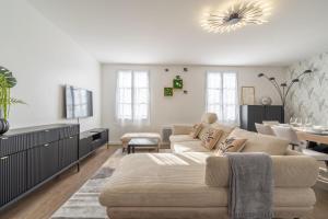 a living room with a couch and a tv at Apart' MIN - Disneyland Paris - 3 Bedrooms - 2 Parking Spots in Bailly-Romainvilliers