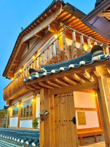 a wooden house with a deck with a roof at 경주 황리단길 한옥스테이 다가감 in Gyeongju