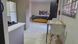 a room with a kitchen and a bedroom with a bed at 43 on Bergview in Hilton