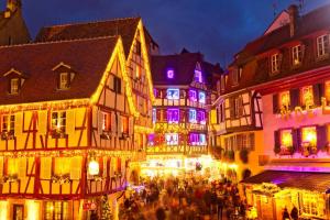 a group of buildings with christmas lights on them at jujuouragan in Saint Die