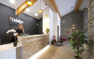 a woman standing at the reception desk of a tea grand at Résidence Odalys Le Grand Panorama 1 in Valmeinier +33 photos