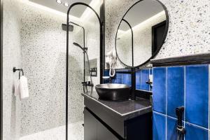 a bathroom with a sink and a mirror at The 2 BDR Sapphire Condo K 5 min to CAI Airport in Cairo