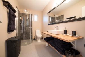 a bathroom with a sink and a shower at Icelandic Cottages in Hraunmörk