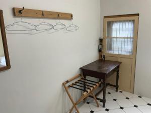 a room with a wooden desk and a door at H. 1967 in Changhua City