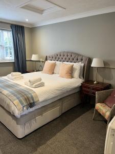a bedroom with a large bed with pillows on it at St Marys Gate Inn in Arundel