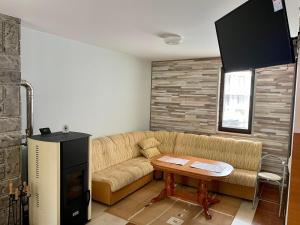 a living room with a couch and a table at St Georgi in Pamporovo