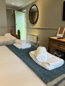 a room with two beds with towels on the floor at St Marys Gate Inn in Arundel