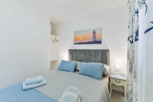 1 dormitorio con 1 cama con almohadas azules y un faro en Villa Anna with pool, Zadar County, en Vinjerac 27 fotos más