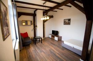 a bedroom with a bed and a chair in a room at NEU! FeWo Märchenstube in Alsfeld