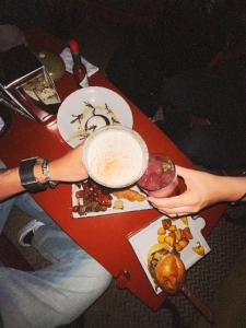 a person holding a bowl of food on a table at The Click Clack Hotel Bogotá in Bogotá