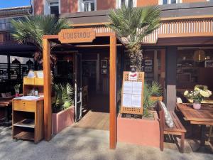 a restaurant with a sign on the front of it at L'Oustaou De Porquerolles in Porquerolles