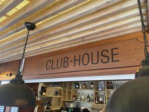 a club house sign hanging over a bar at L'Oustaou De Porquerolles in Porquerolles