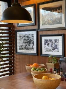 a dining room with bowls of fruit on a table at L'Oustaou De Porquerolles in Porquerolles