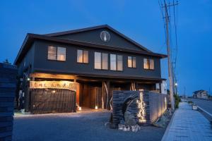 a black house with a fence in front of it at 割烹旅館 清都 in Hongō