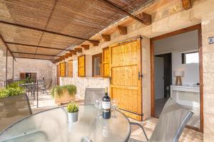 a table with a bottle of wine on a patio at Apartamento Son Calo B by Rentallorca in Petra