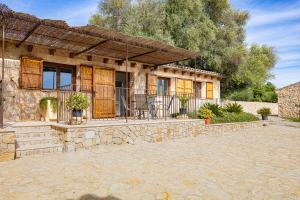 a stone house with a porch and a patio at Apartamento Son Calo B by Rentallorca in Petra