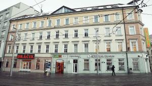 a large white building on the corner of a street at Hostel Folks in Bratislava