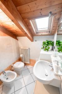 a bathroom with a toilet and a sink at Casa Margot in Asti +26 photos