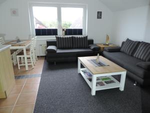 a living room with two couches and a coffee table at Ferienwohnung Pauly in Niesgrau