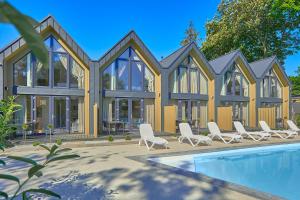 a rendering of a house with a swimming pool at Domki Premium Nautica blisko plaży in Rewal