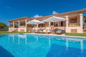 a swimming pool in front of a house at Villa Mar y Tierra in La Cabaneta