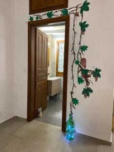 a bathroom with a door with a bottle on the wall at Winter Summer House in Mouresi +11 photos