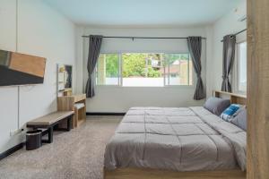 une chambre avec un lit et une grande fenêtre dans l'établissement Pool Villa 3 Bedrooms, Closeby Patong, Chic and Quiet, à Ban Thung Thong