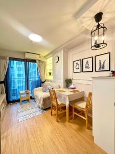a living room with a bed and a table and chairs at AnnaHomeB139Latkrabang in Ban Khlong Prawet +29 photos