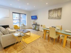 a living room with a couch and a table at Pass the Keys Mill Conversion Flat Mins from City Bars Shops in Manchester