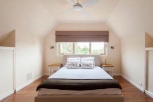 a bedroom with a large bed with a window at The Nest at Gundaroo in Gundaroo