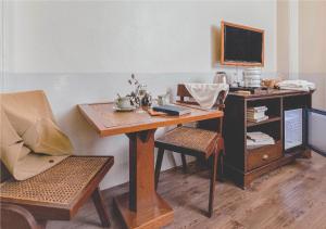 a room with a desk and a table and a chair at Yesterday Hotel in Chiang Mai