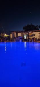 a large blue swimming pool at night at Hotel Bellavista in Sant'Angelo D'Ischia