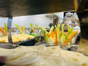 a buffet line with different types of food in bowls at Hotel Butterfly Wellness & Spa in Rimini