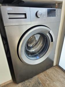 a washing machine with its door open in a room at Be Lazy with a Sea View in Jeffreys Bay +21 photos