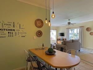 a living room with a table and a couch at Anka's Cozy Holiday Home in Swakopmund